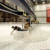 Technicians loading chunks of glass onto the honeycomb casting mold
